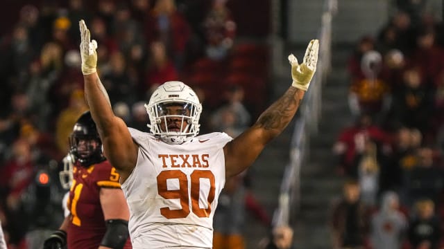 Texas Longhorns defensive lineman Byron Murphy II (90) celebrates sacking Iowa State quarterback Rocco Becht (3) during the game at Jack Trice Stadium on Saturday, Nov. 8, 2023 in Ames, Iowa.