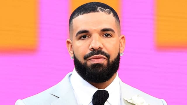 Music icon Drake poses on the red carpet.
