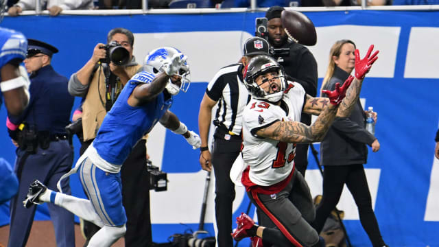 Jan 21, 2024; Detroit, Michigan, USA; Tampa Bay Buccaneers wide receiver Mike Evans (13) reaches for the ball against the Detroit Lions during the first half in a 2024 NFC divisional round game at Ford Field. Mandatory Credit: Lon Horwedel-USA TODAY Sports