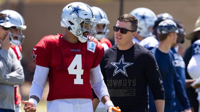 Dallas Cowboys quarterback Dak Prescott (4) talks with offensive coordinator Kellen Moore during training camp at River Ridge Playing Fields in Oxnard, California.