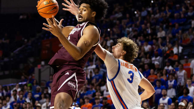 Mississippi State Bulldogs forward Tolu Smith (1) grabs a rebound over Florida Gators center Micah Handlogten (3) during the first half at Exactech Arena at the Stephen C. O'Connell Center.