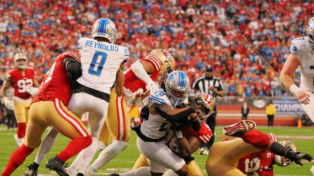Detroit Lions Jahmyr Gibbs is tackled by the San Francisco 49ers defense.
