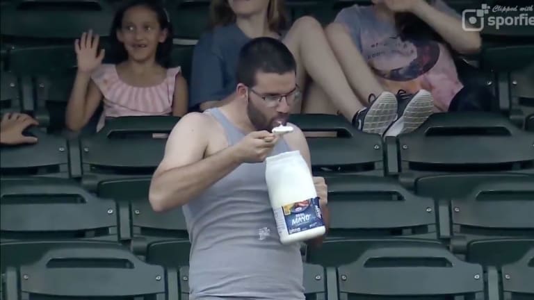 Man Keeps Eating From Giant Mayo Tub at Minor League Game
