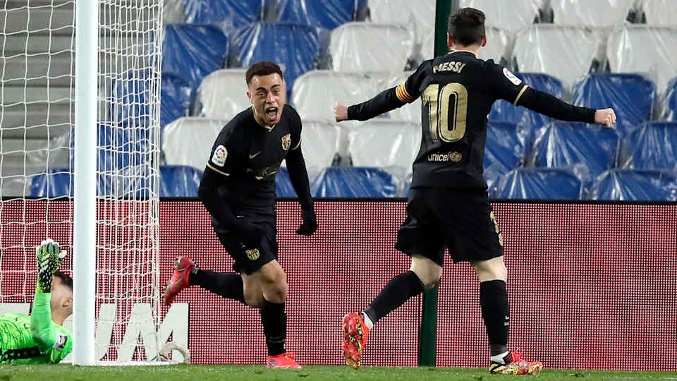 Sergiño Dest celebrates with Lionel Messi after scoring for Barcelona