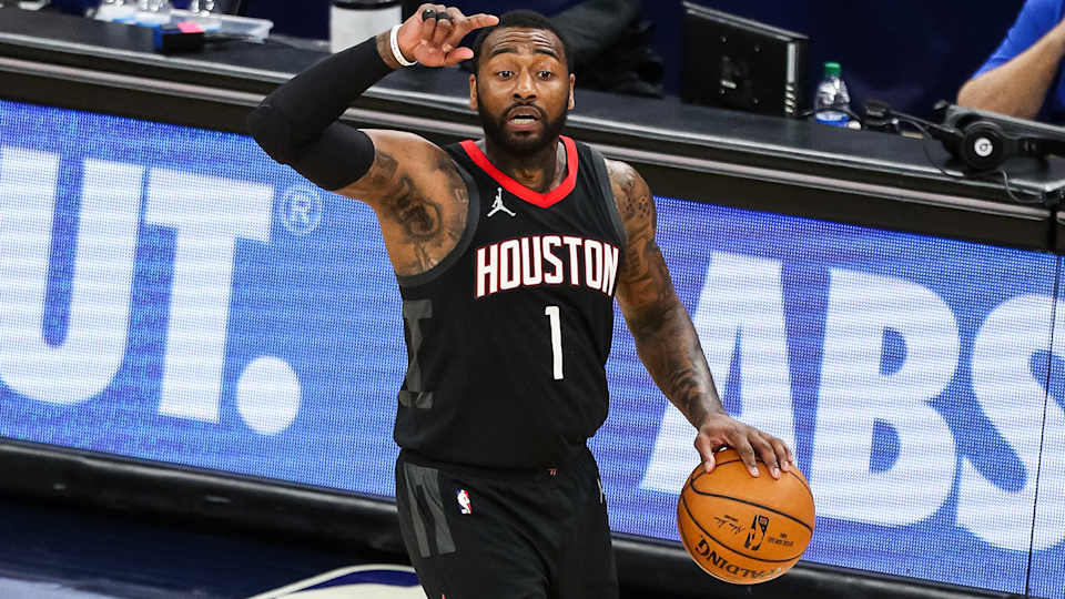 Houston Rockets point guard John Wall dribbles a basketball.