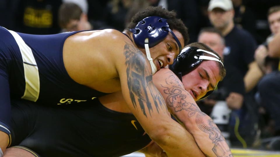 Penn State's Greg Kerkvliet (top) wrestles against Iowa's Ben Kueter in a Big Ten wrestling match at Carver-Hawkeye Arena.