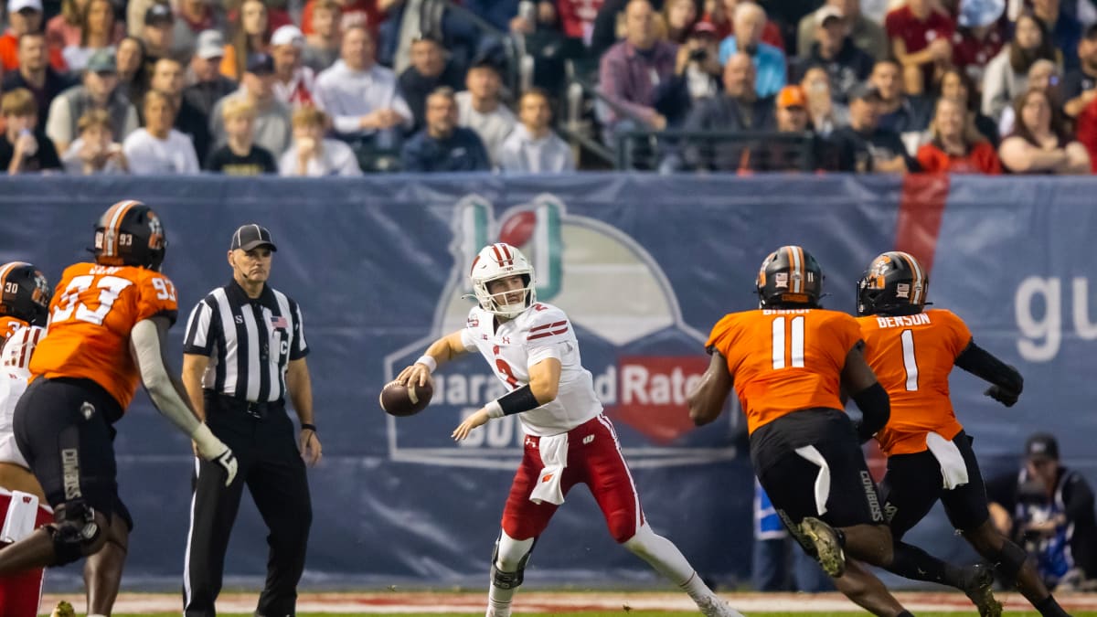 Dec 27, 2022; Phoenix, Arizona, USA; Wisconsin Badgers quarterback Chase Wolf (2) against the Oklahoma State Cowboys in the first half of the 2022 Guaranteed Rate Bowl at Chase Field. Mandatory Credit: Mark J. Rebilas-USA TODAY Sports