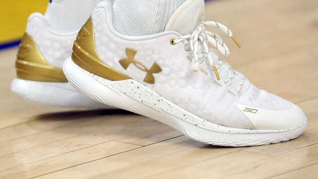 White and Gold Curry 1 shoes.