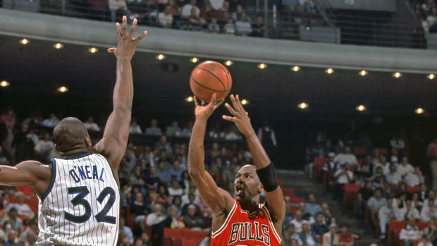 Chicago Bulls guard Michael Jordan shoots over Orlando Magic center Shaquille O' Neal
