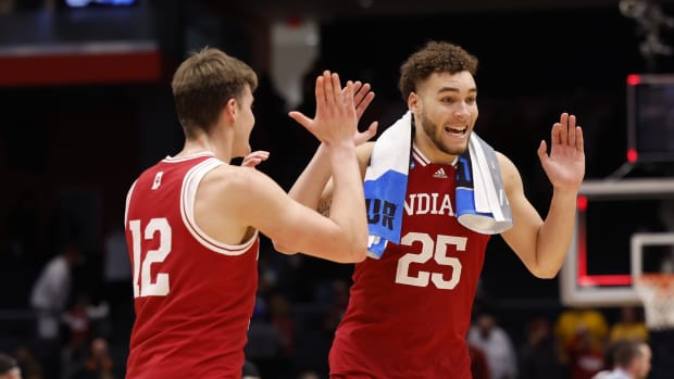 Indiana Hoosiers forward Miller Kopp (12) celebrates with Indiana Hoosiers forward Race Thompson (25) after defeating Wyoming Cowboys during the First Four of the 2022 NCAA Tournament at UD Arena.