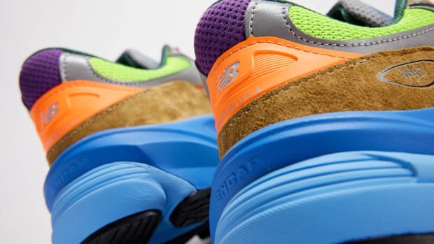View of brown, blue, and green New Balance shoes.