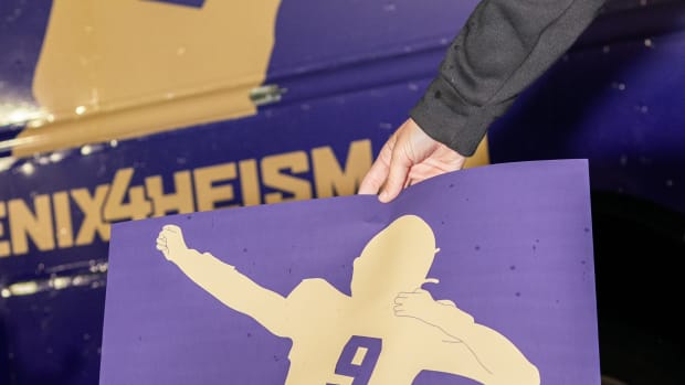 A purple and gold adidas sign reading, "#Penix4Heisman."