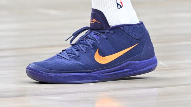 View of Devin Booker's purple and orange Nike shoes.