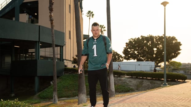 Mike Trout wearing a Philadelphia Eagles jersey, and black/white shoes.