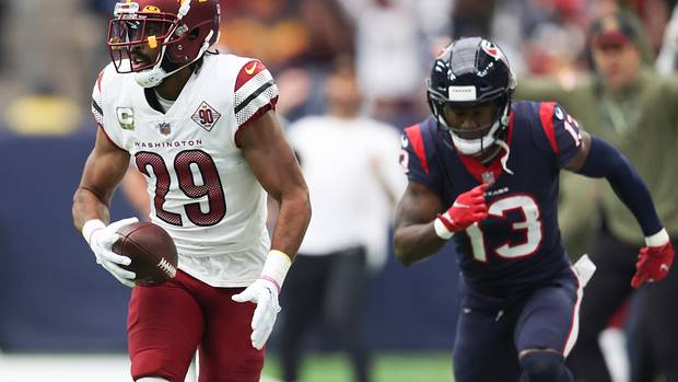 Washington Commanders cornerback Kendall Fuller (29) intercepts the ball against Houston Texans wide receiver Brandin Cooks (13) for a touchdown reception in the first quarter at NRG Stadium.