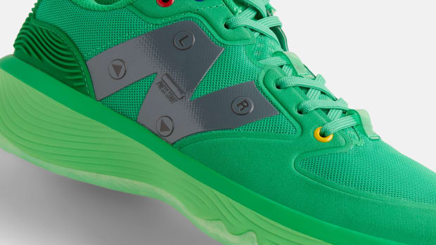 Side view of a green New Balance basketball shoe.