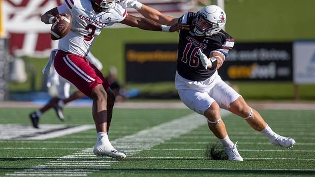 Aggie linebacker Gabe Peterson reaches for UMass quarterback Taisun Phommachanh during an Aggie football game on Saturday, August 256 2023, at the Aggie Memorial Stadium.