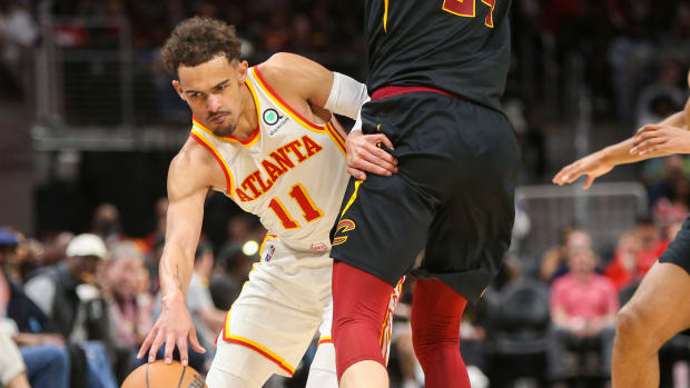 Trae Young drives past a Cavaliers defender.