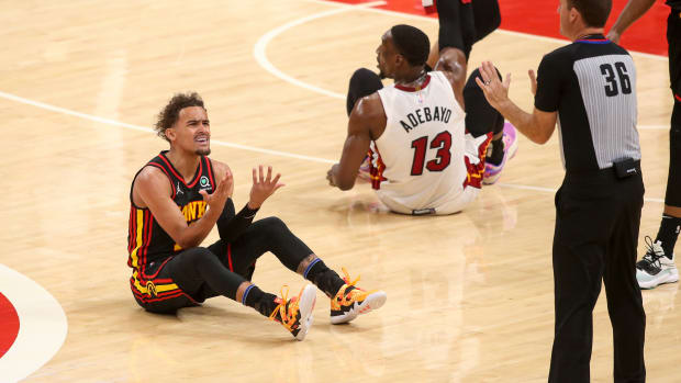 Apr 24, 2022; Atlanta, Georgia, USA; Atlanta Hawks guard Trae Young (11) reacts after being called for a foul by referee Brent Barnaky (36) against the Miami Heat in the first quarter during game four of the first round for the 2022 NBA playoffs at State Farm Arena.