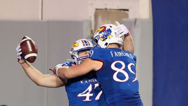 Dec 28, 2022; Memphis, TN, USA; Kansas Jayhawks tight end Jared Casey (47) celebrates with tight end Mason Fairchild (89) after scoring a touchdown in the second overtime against the Arkansas Razorbacks in the 2022 Liberty Bowl at Liberty Bowl Memorial Stadium. Arkansas won 55-53. Mandatory Credit: Nelson Chenault-USA TODAY Sports  