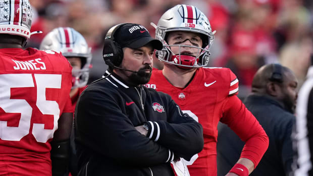Ohio State Buckeyes quarterback Kyle McCord (6) looks at a replay on the scoreboard behind head coach Ryan Day during the NCAA football game against the Minnesota Golden Gophers at Ohio Stadium