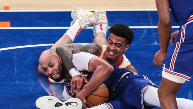 New York Knicks center Taj Gibson (67) and Atlanta Hawks forward John Collins (20) fight for a loose ball in the third quarter during game five in the first round of the 2021 NBA Playoffs at Madison Square Garden.