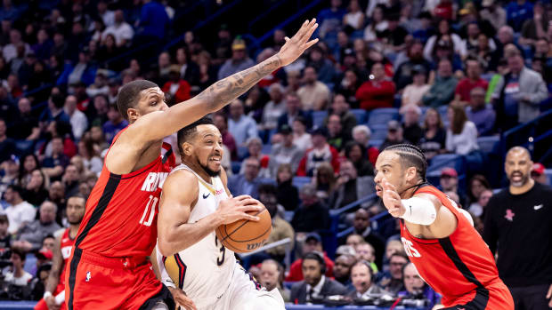 New Orleans Pelicans dribbles against Houston Rockets forward Jabari Smith Jr. (10) and forward Dillon Brooks (9) during the first half at Smoothie King Center.