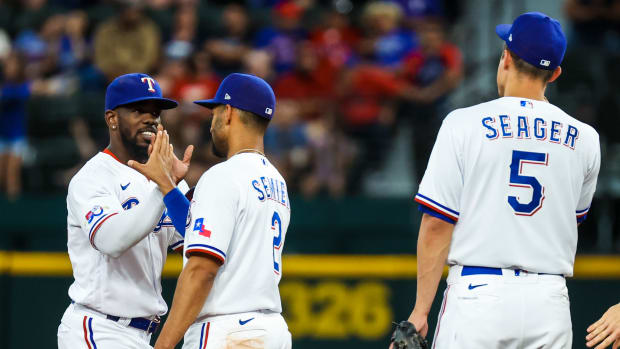 Jun 4, 2022; Arlington, Texas, USA; Texas Rangers right fielder Adolis Garcia (left) celebrates with Texas Rangers second baseman Marcus Semien (2) and Texas Rangers shortstop Corey Seager (5) after the game against the Seattle Mariners at Globe Life Field. Mandatory Credit: Kevin Jairaj-USA TODAY Sports  
