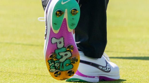View of Rory McIlroy's white, green, and purple Nike golf shoes.