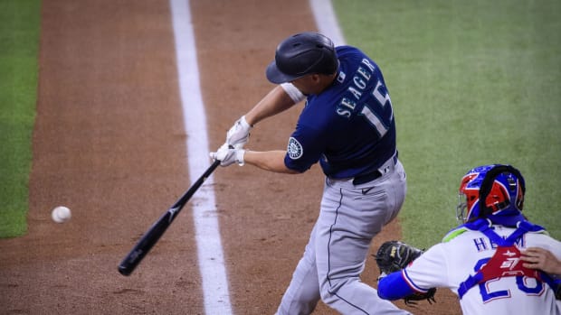Aug 19, 2021; Arlington, Texas, USA; Seattle Mariners third baseman Kyle Seager (15) hits a double and drives in a run against the Texas Rangers during the first inning at Globe Life Field. Mandatory Credit: Jerome Miron-USA TODAY Sports