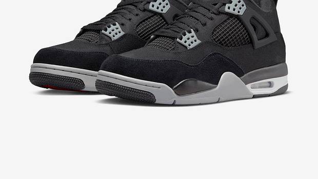 View of black and grey Air Jordan 4 shoes.