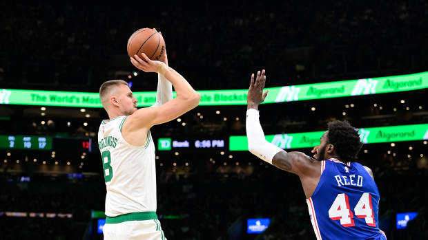 Boston Celtics center Kristaps Porzingis (8) shoots against Philadelphia 76ers forward Paul Reed (44) during the first half at TD Garden.