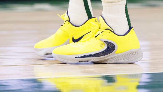 View of Giannis Antetokounmpo's yellow and black Nike shoes.