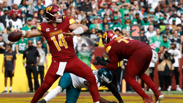 Washington Commanders quarterback Sam Howell (14) passes the ball from his end zone against the Philadelphia Eagles during the third quarter at FedExField.