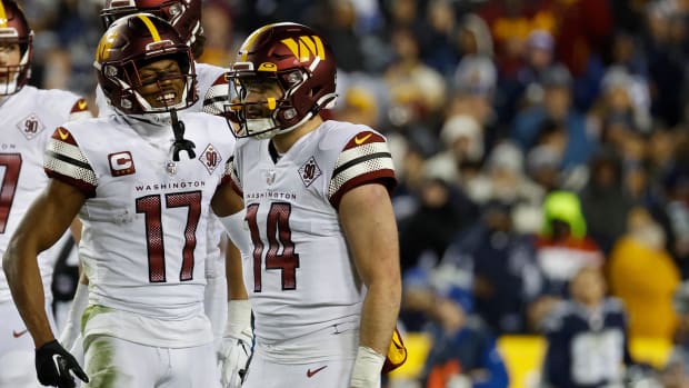 Washington Commanders quarterback Sam Howell (14) and receiver Terry McLaurin (17) celebrate a play in Week 18.