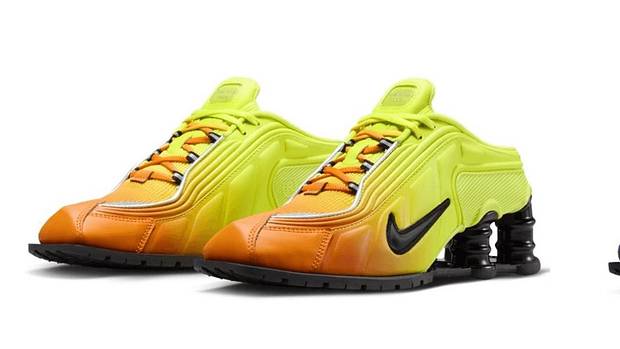 Side view of orange and blue Nike Shox sneakers.