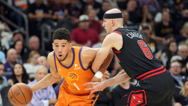 March 18, 2022; Phoenix Suns star Devin Booker on offense vs. Chicago Bulls guard Alex Caruso