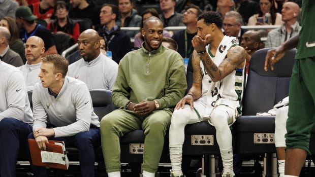 Milwaukee Bucks forward Khris Middleton enjoys a moment on the bench with guard George Hill (3)