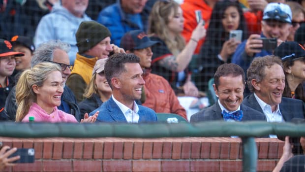 Legendary SF Giants catcher Buster Posey sits in the stands with Kristen Posey (left) and Ken Rosenthal (right).