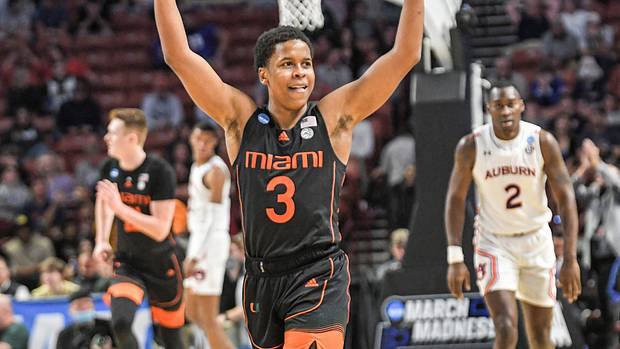 University of Miami guard Charlie Moore (3) celebrates after teammate forward Sam Waardenburg (21) dunked against Auburn University.
