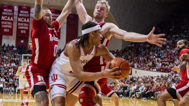 Feb 21, 2024; Bloomington, Indiana, USA; Indiana Hoosiers forward Malik Reneau looks to pass while Nebraska Cornhuskers guard C.J. Wilcher (0) and forward Rienk Mast defend in the first half at Simon Skjodt Assembly Hall.