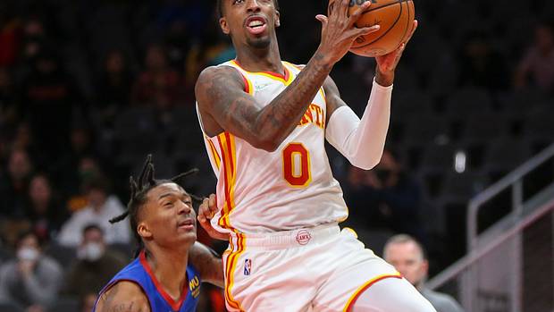 Atlanta Hawks guard Delon Wright shoots a layup against the Denver Nuggets.