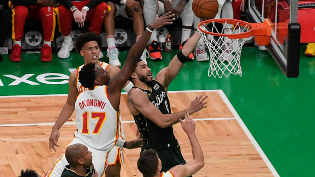 Boston Celtics forward Jayson Tatum shoots over Atlanta Hawks forward Onyeka Okongwu.