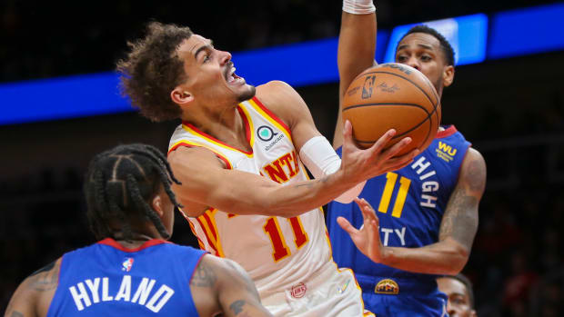 Hawks guard Trae Young shoots over Nuggets guard Monte Morris.
