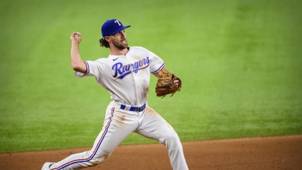 Former Texas Rangers third baseman Charlie Culberson throws to first base during a game in 2021. Culberson is attempting to make the Atlanta Braves roster as a pitcher.