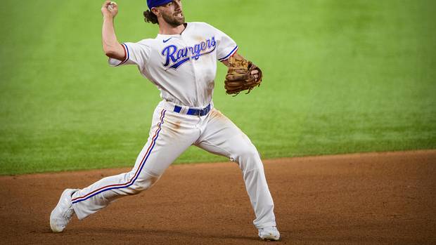 Former Texas Rangers third baseman Charlie Culberson throws to first base during a game in 2021. Culberson is attempting to make the Atlanta Braves roster as a pitcher.