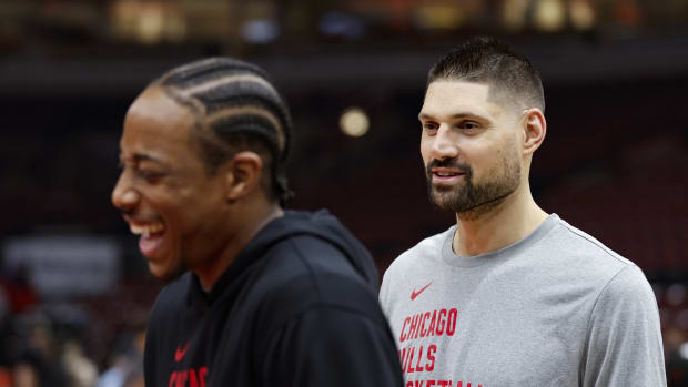 Chicago Bulls center Nikola Vucevic (R) jokes with forward DeMar DeRozan (L) before a basketball game against the Minnesota Timberwolves