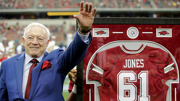 Dallas Cowboys owner Jerry Jones is presented with his Arkansas Razorbacks jersey at half time of the game against the Texas A&M Aggies at AT&T Stadium.