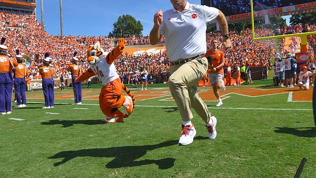 Clemson Tigers head coach Dabo Swinney runs on the field before a game.