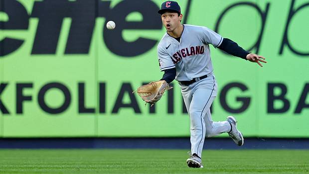Steven Kwan makes a running, basket-style catch in left field.